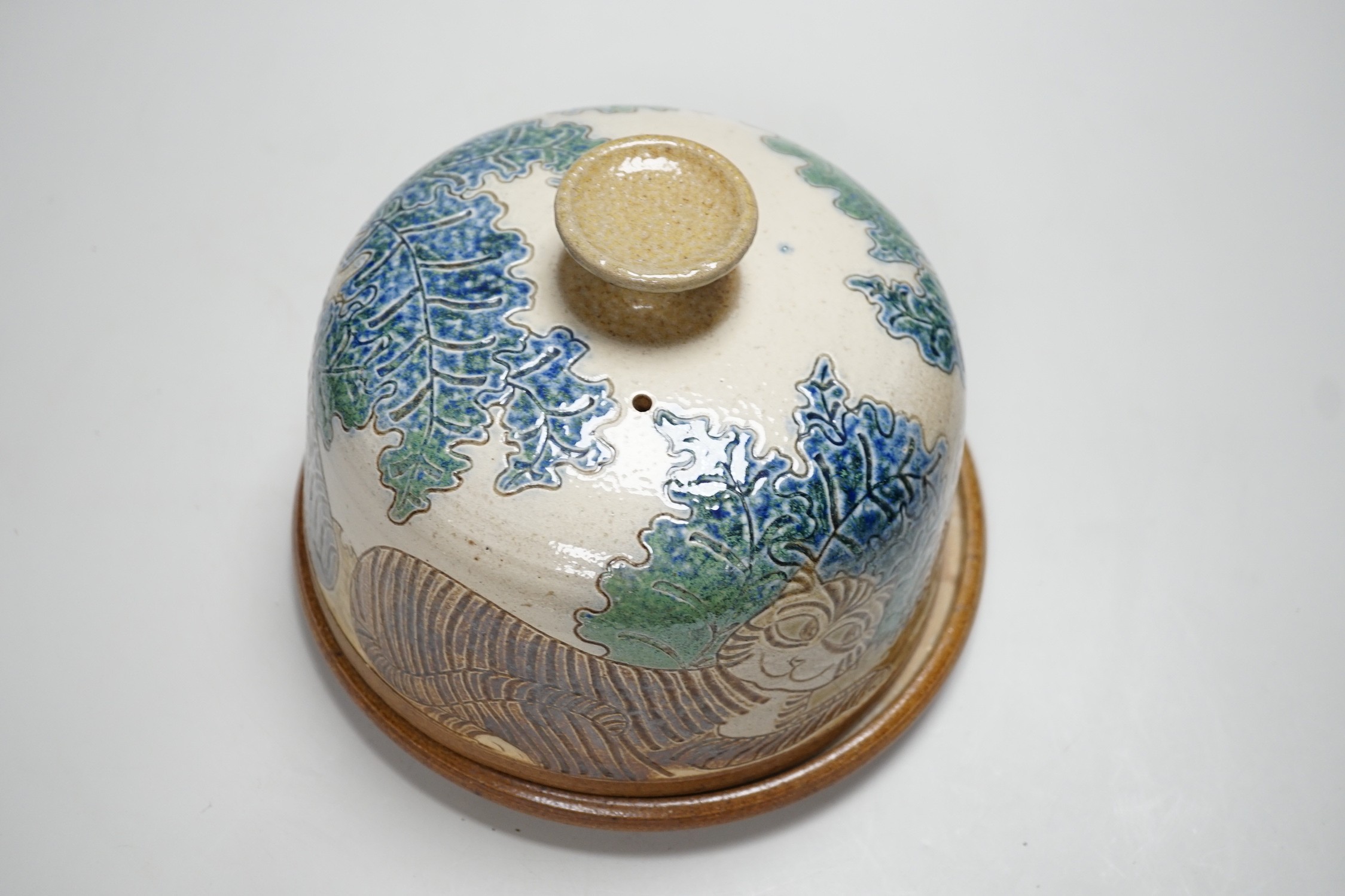 Michael Mosse, a studio pottery cheese dish and cover, decorated with cats, 16cms high